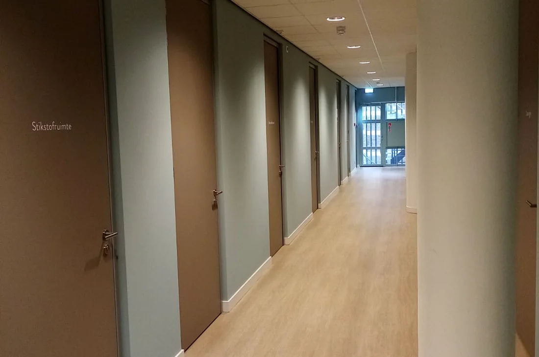 Corridor with recessed spots and emergency exit lighting in a commercial building